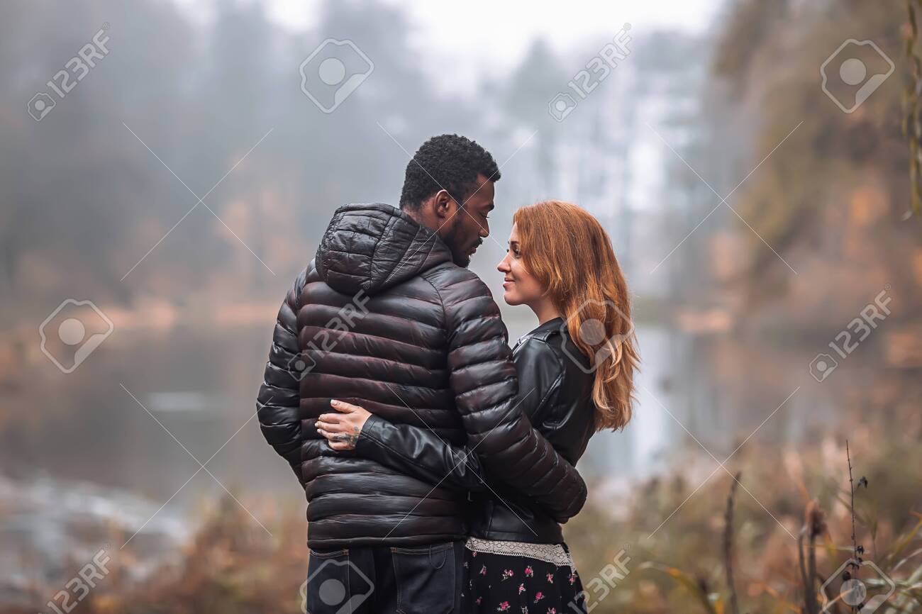 Interracial Couple Posing In Autumn