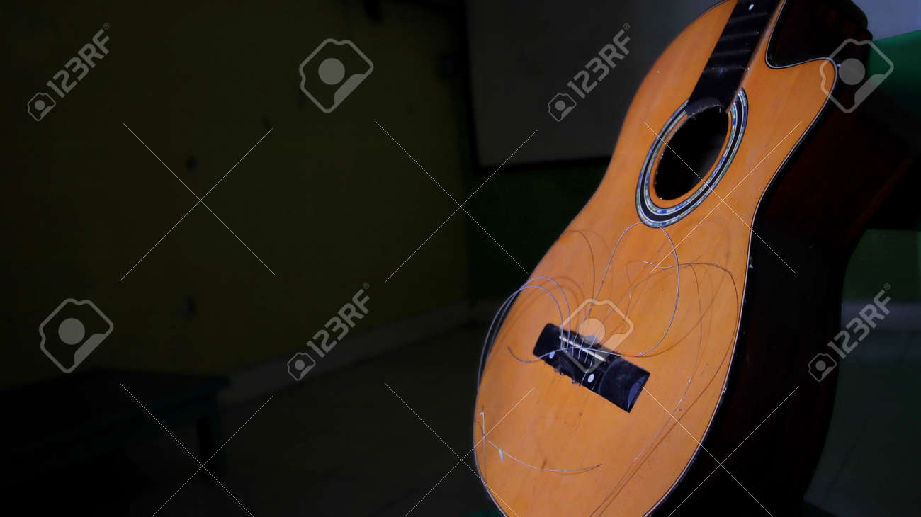 Not focus and noise image, damaged acoustic guitar, with the strings not attached, can't be plucked - 166878087 Not focus and noise image, damaged acoustic guitar, with the strings not attached, can't be plucked - 166878087