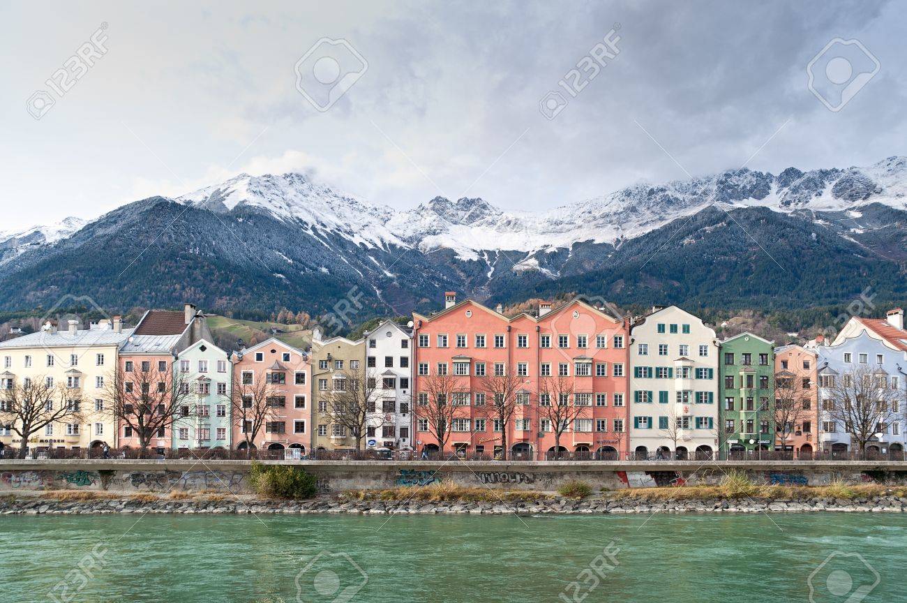 row of houses in innsbruck in the background the austrian alps