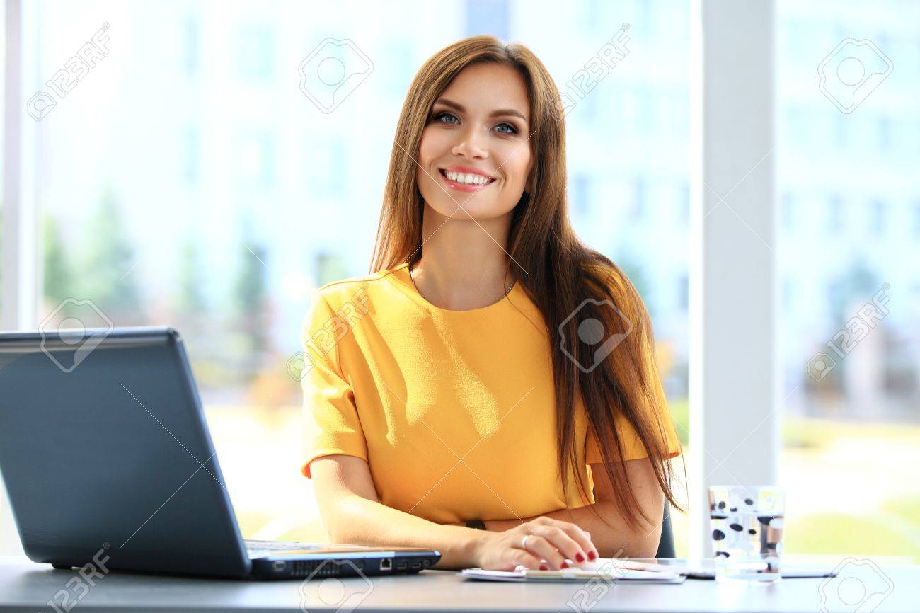 Portrait of a young business woman using laptop at office - 48284661 Portrait of a young business woman using laptop at office - 48284661