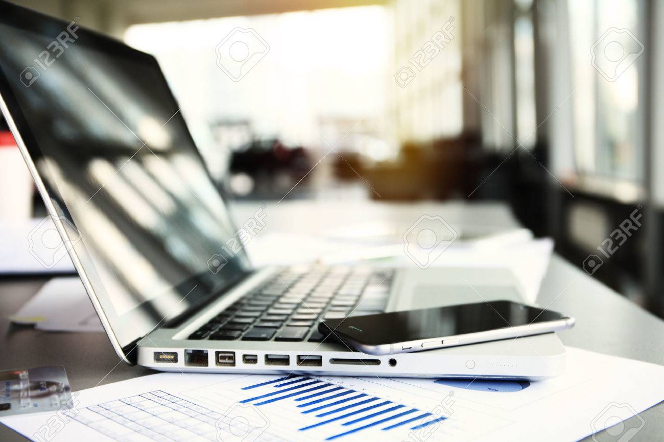 Office workplace with laptop on wood table against the windows. - 58765353 Office workplace with laptop on wood table against the windows. - 58765353