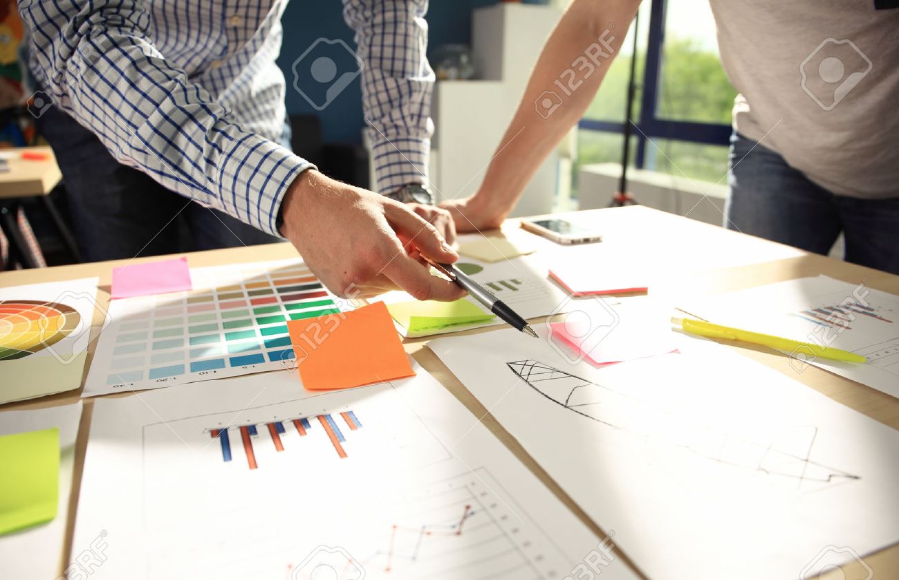 Business team brainstorming. Marketing plan researching. Paperwork on the table, laptop and mobile phone - 65005539 Business team brainstorming. Marketing plan researching. Paperwork on the table, laptop and mobile phone - 65005539