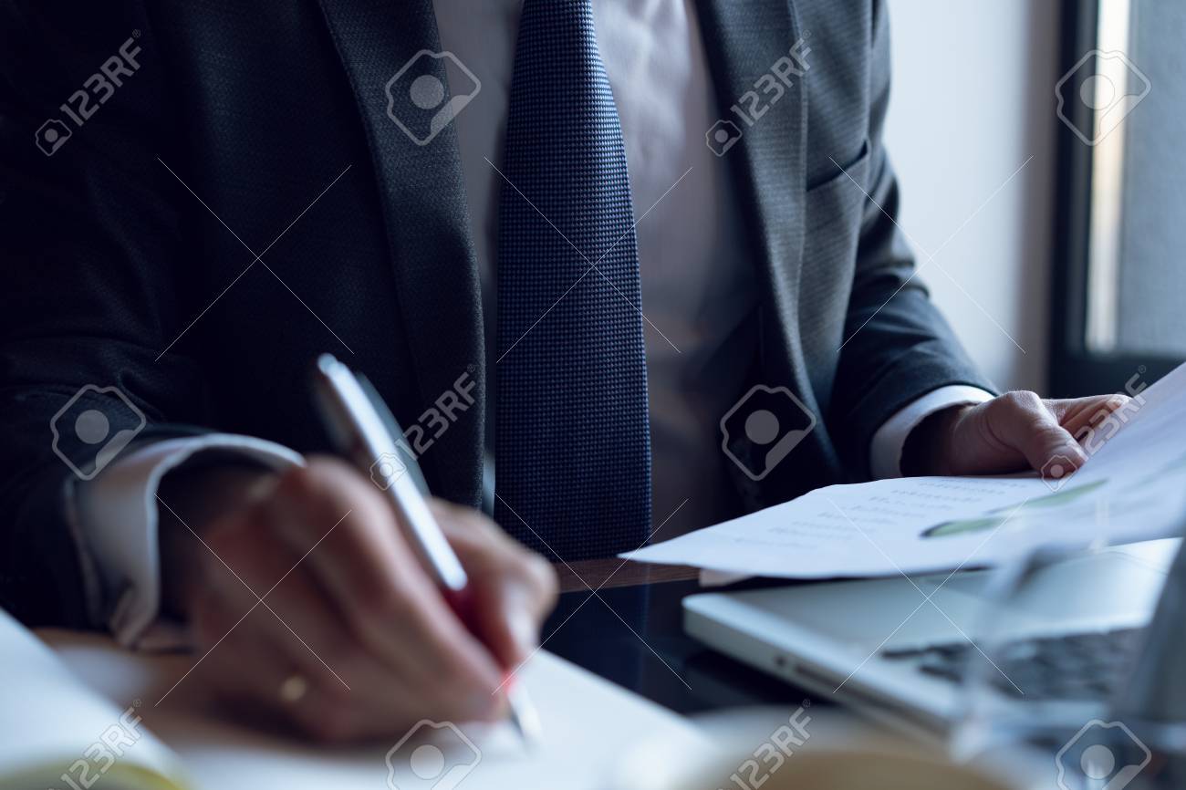 Businessman analyzing investment charts. Accounting. Hands of financial manager taking notes while working. - 113386289 Businessman analyzing investment charts. Accounting. Hands of financial manager taking notes while working. - 113386289