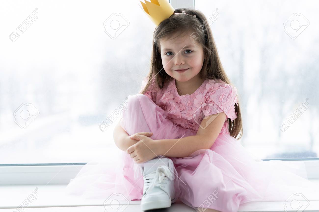 Cute little girl in a princess costume. Pretty child preparing for a costume party. Beautiful queen in gold crown. - 117980184 Cute little girl in a princess costume. Pretty child preparing for a costume party. Beautiful queen in gold crown. - 117980184