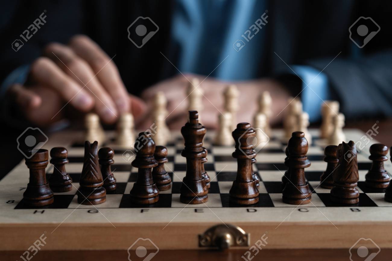 Businessman play with chess game. concept of business strategy and tactic. - 119770109 Businessman play with chess game. concept of business strategy and tactic. - 119770109