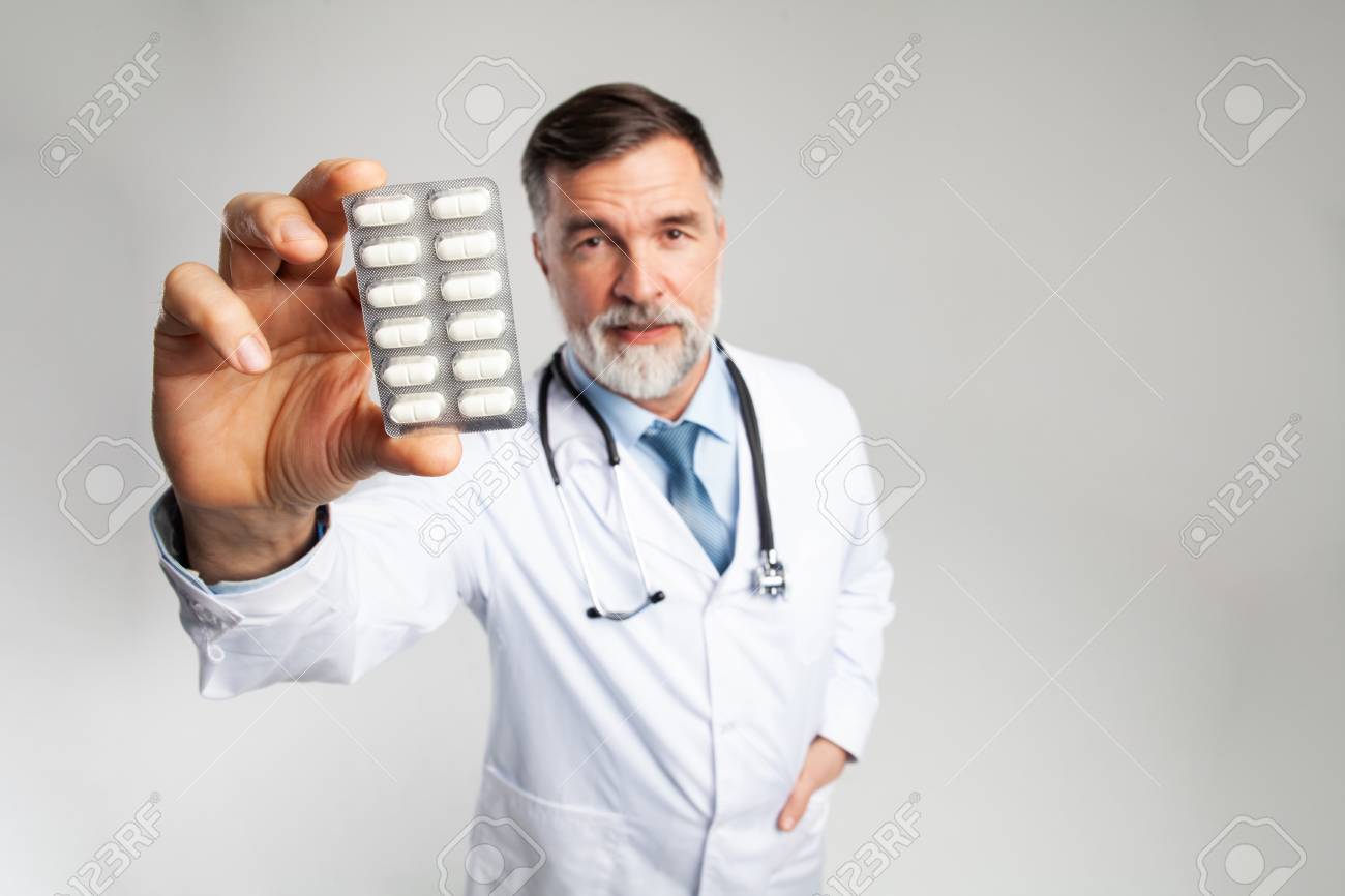 healthcare and medical concept - doctor with pill in hospital - 121958914 healthcare and medical concept - doctor with pill in hospital - 121958914
