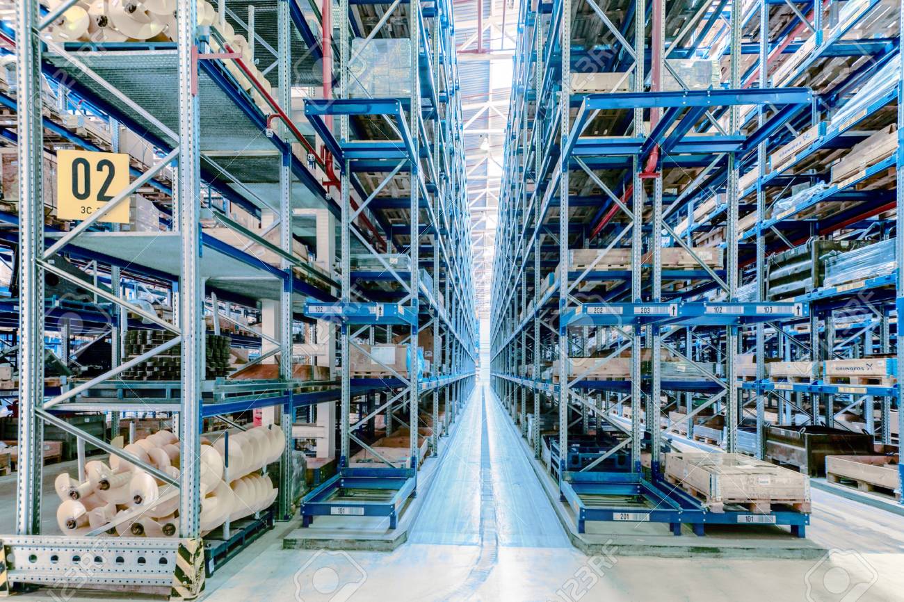 Large storehouse with tall racks full of various wares - 66465041 Large storehouse with tall racks full of various wares - 66465041