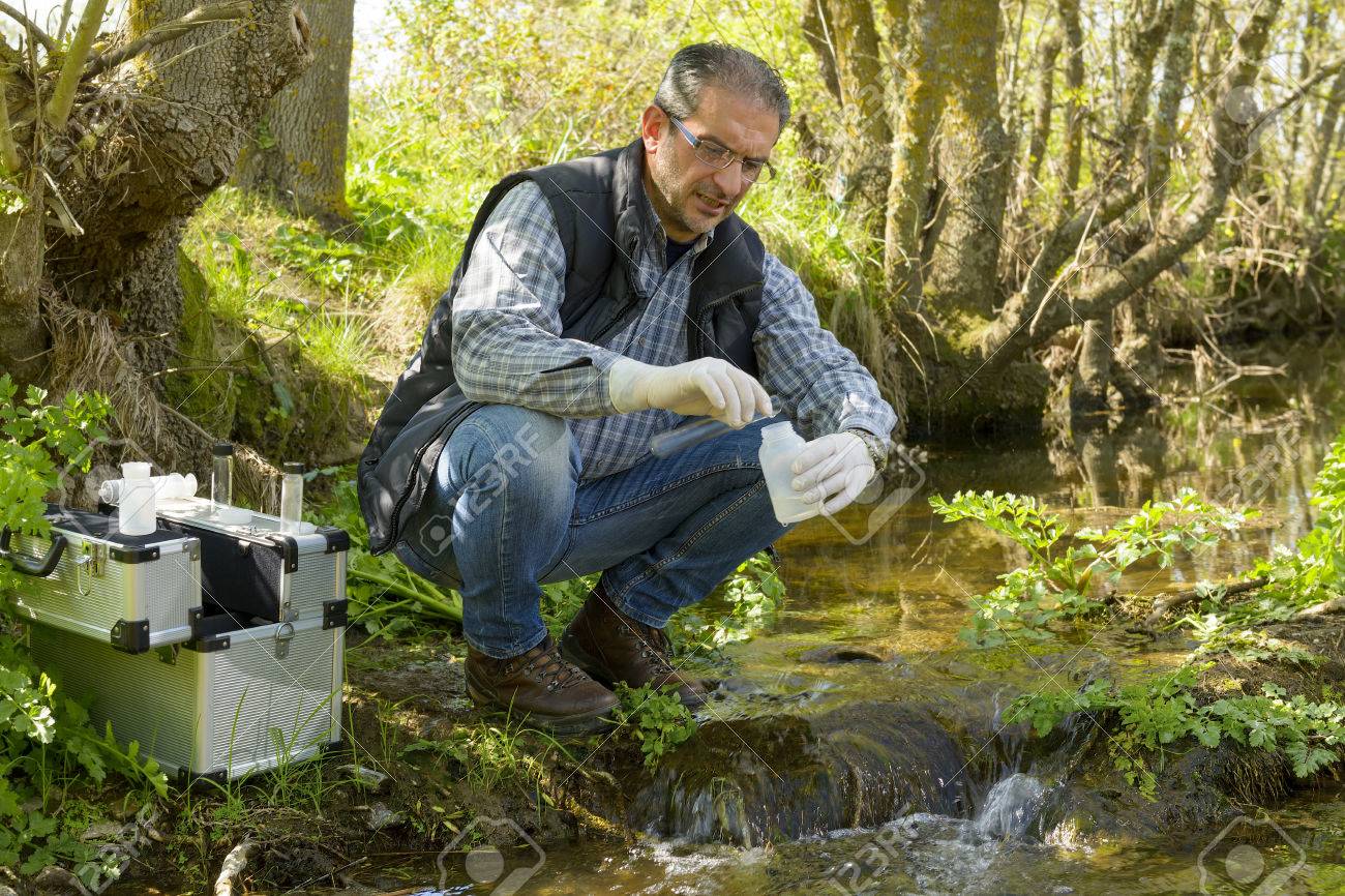 Scientist and biologist hydro-biologist takes water samples for analysis. - 75541508 Scientist and biologist hydro-biologist takes water samples for analysis. - 75541508