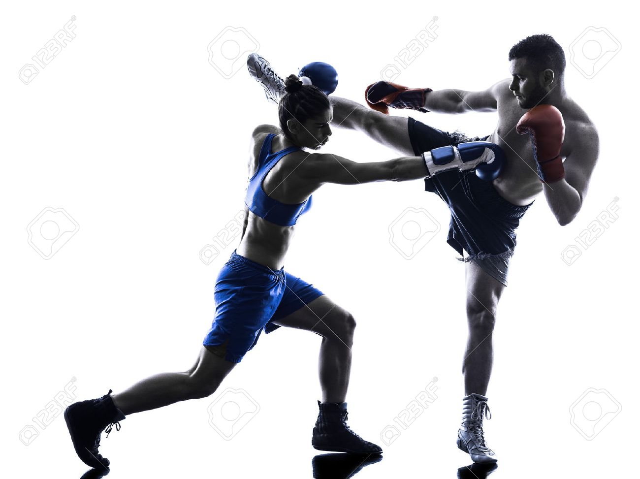 one woman boxer boxing one man kickboxing in silhouette isolated