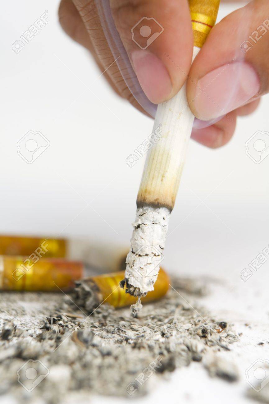 fingers turn off the cigarrete on white ashtray stock photo picture