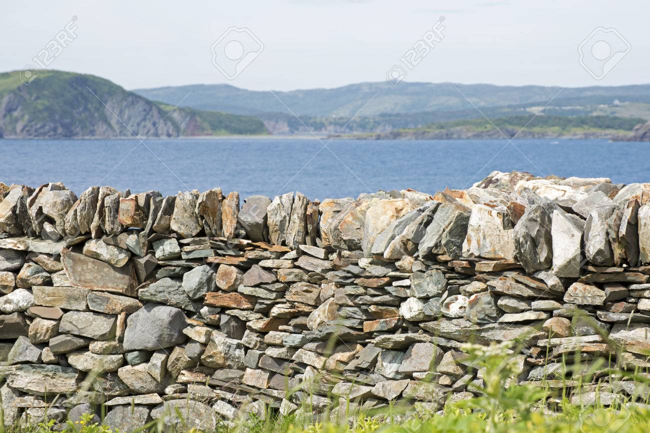stone retaining wall with atlantic ocean in background newfoundland