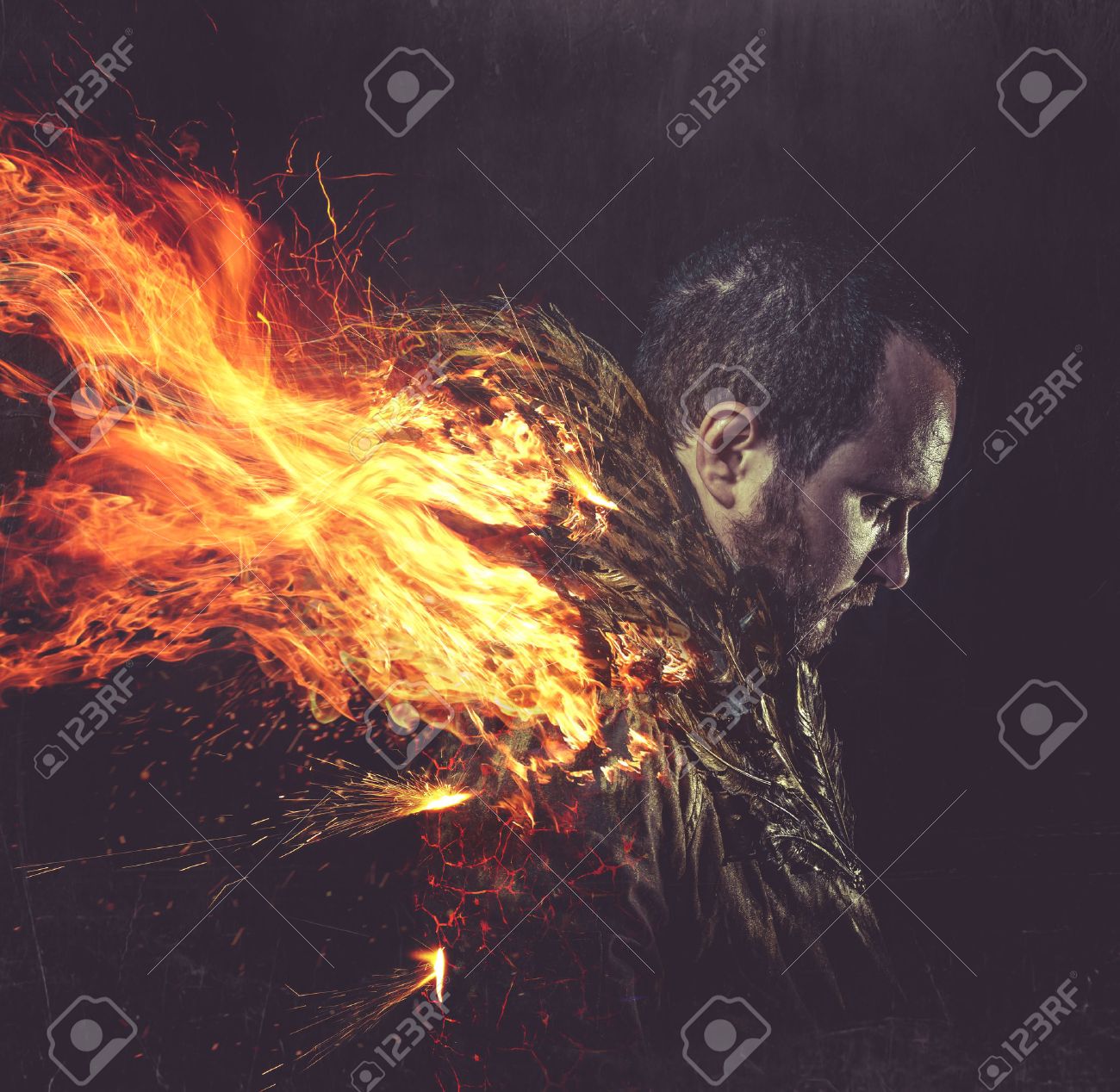 fallen angel, jacket man with golden feathers on the wings and fire - 30572999 fallen angel, jacket man with golden feathers on the wings and fire - 30572999