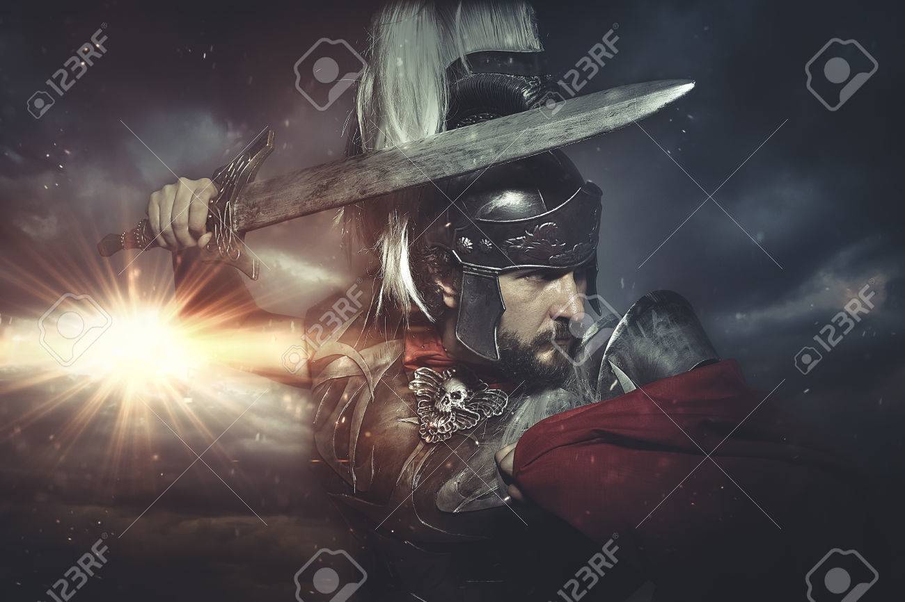 Legionary warrior helmet, armor and red cape on a battlefield, conflict and struggle in the Roman Empire - 57235029 Legionary warrior helmet, armor and red cape on a battlefield, conflict and struggle in the Roman Empire - 57235029
