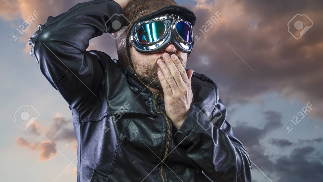 Old Plane Pilot On Background Of Storm Clouds With Expressive Face 