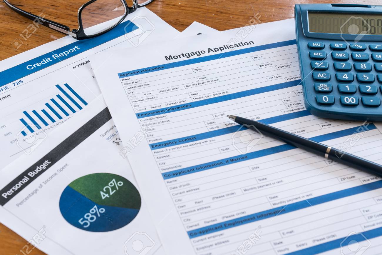 mortgage application on desk with credit report budget calculator