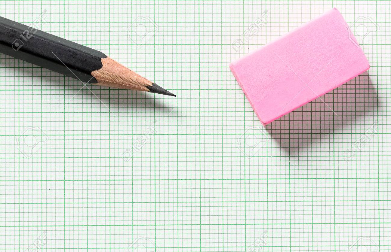 pencil and eraser on green graph paper with copy space selective