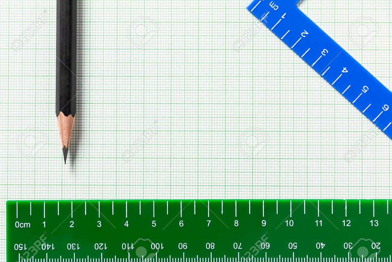 pencil and ruler on green graph paper with copy space stock photo