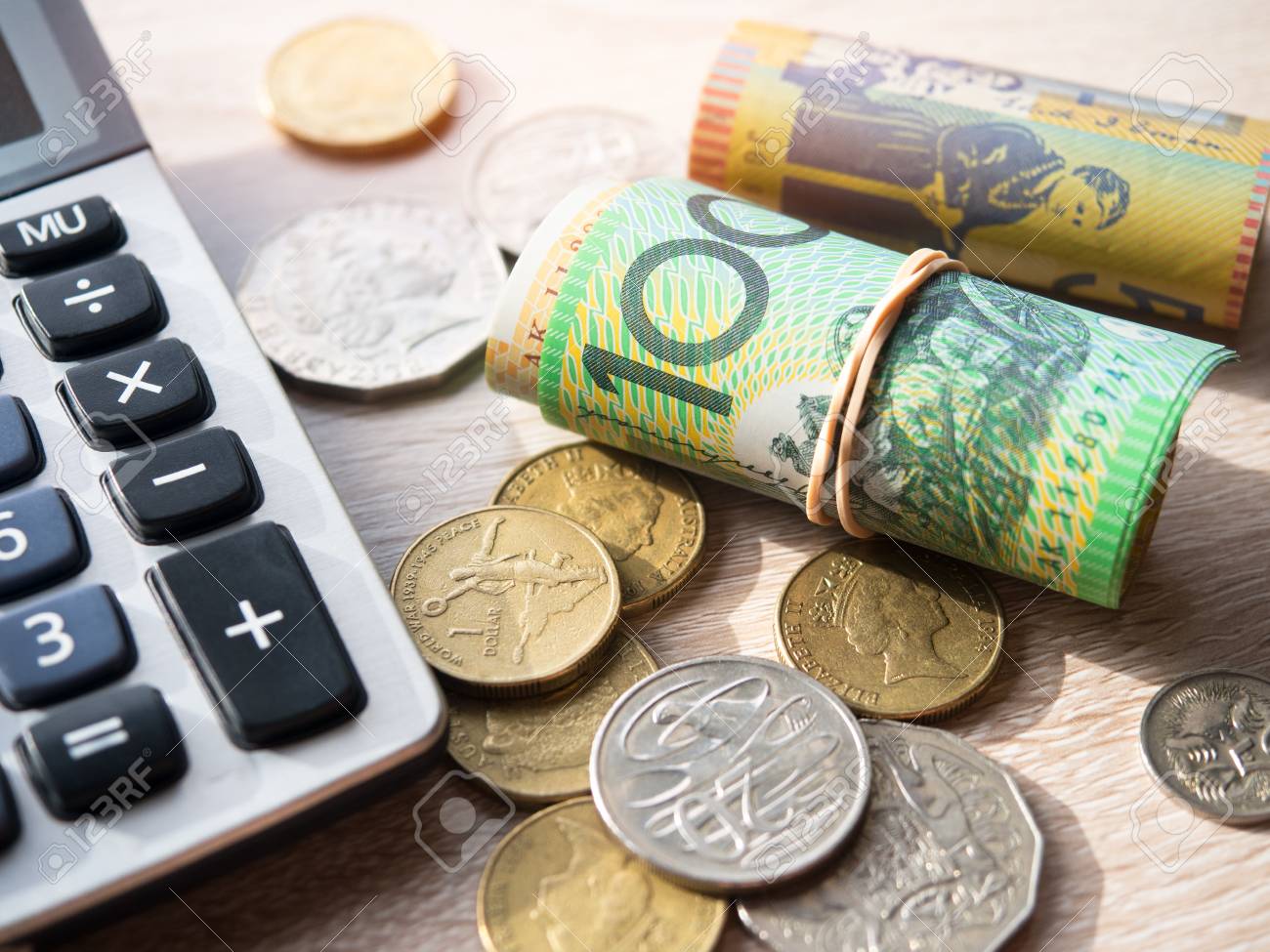 dollar australia banknotes and coins with calculator on table