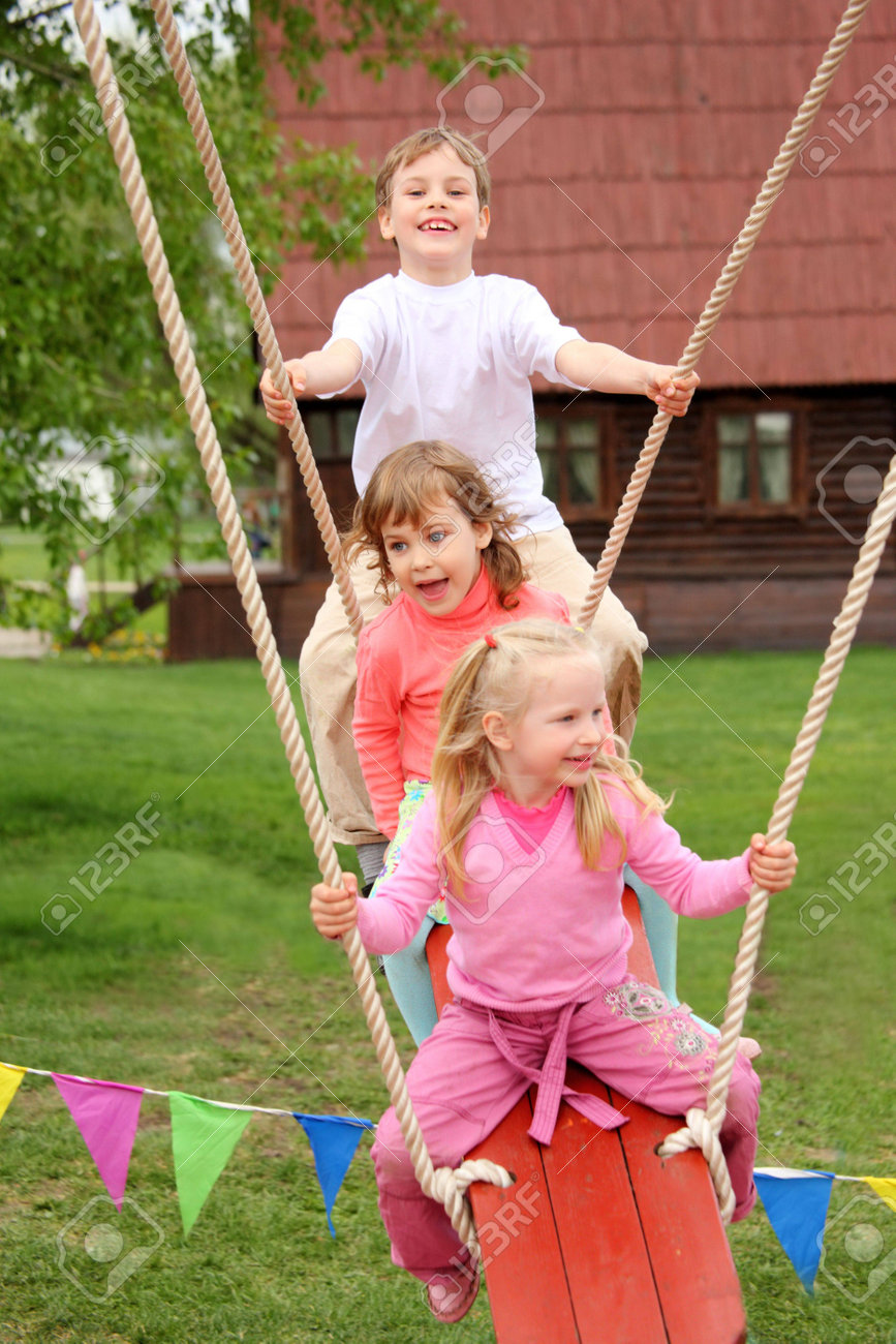three children on swing