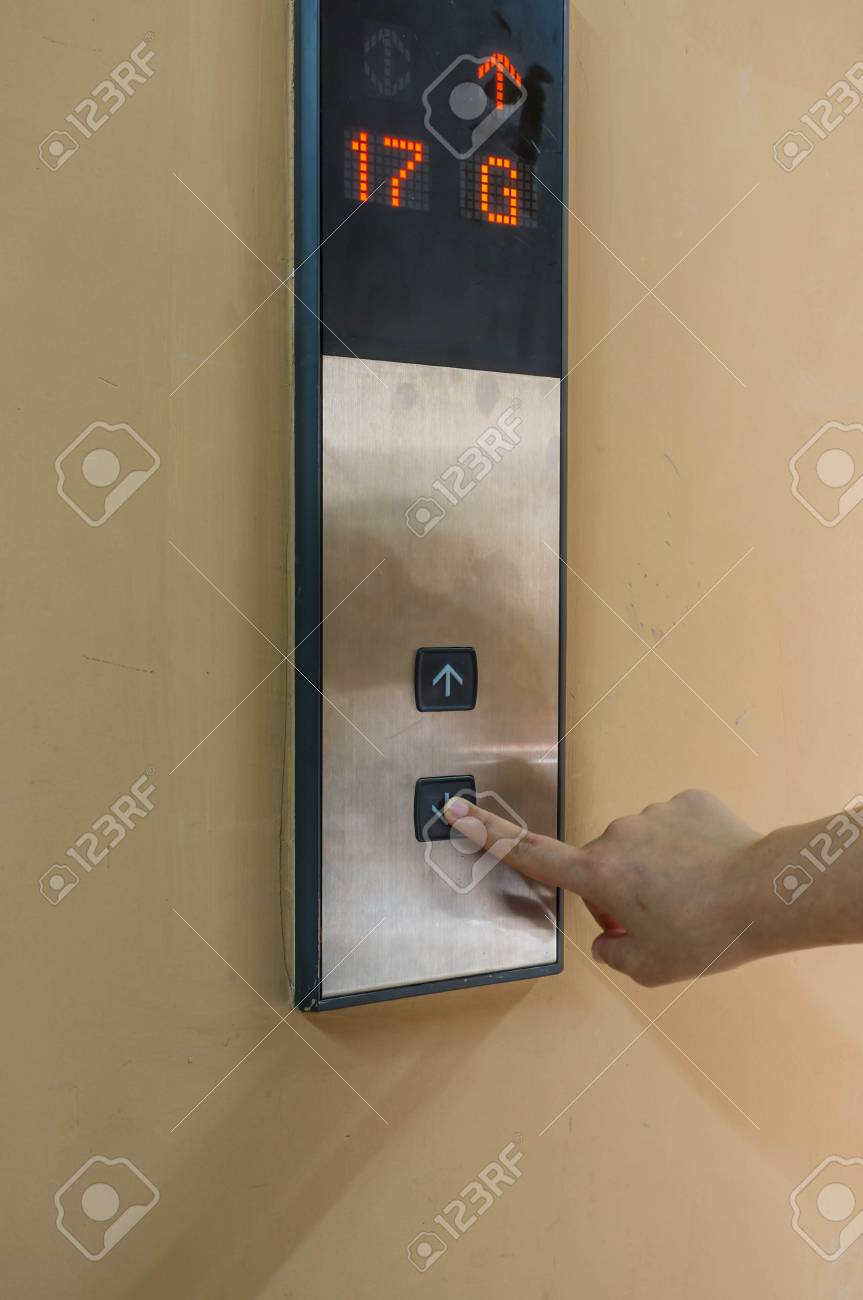 Hand Pressing Down Button Going Down To The Ground Floor Stock