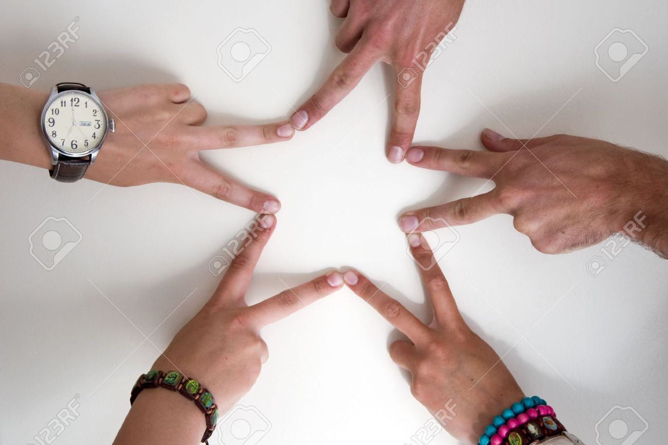 five teenagers hands form a star two boy hands and three girl
