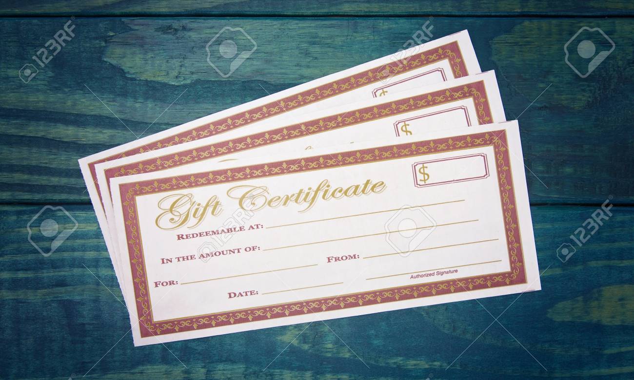 blank gift voucher on a blue wooden table stock photo picture and