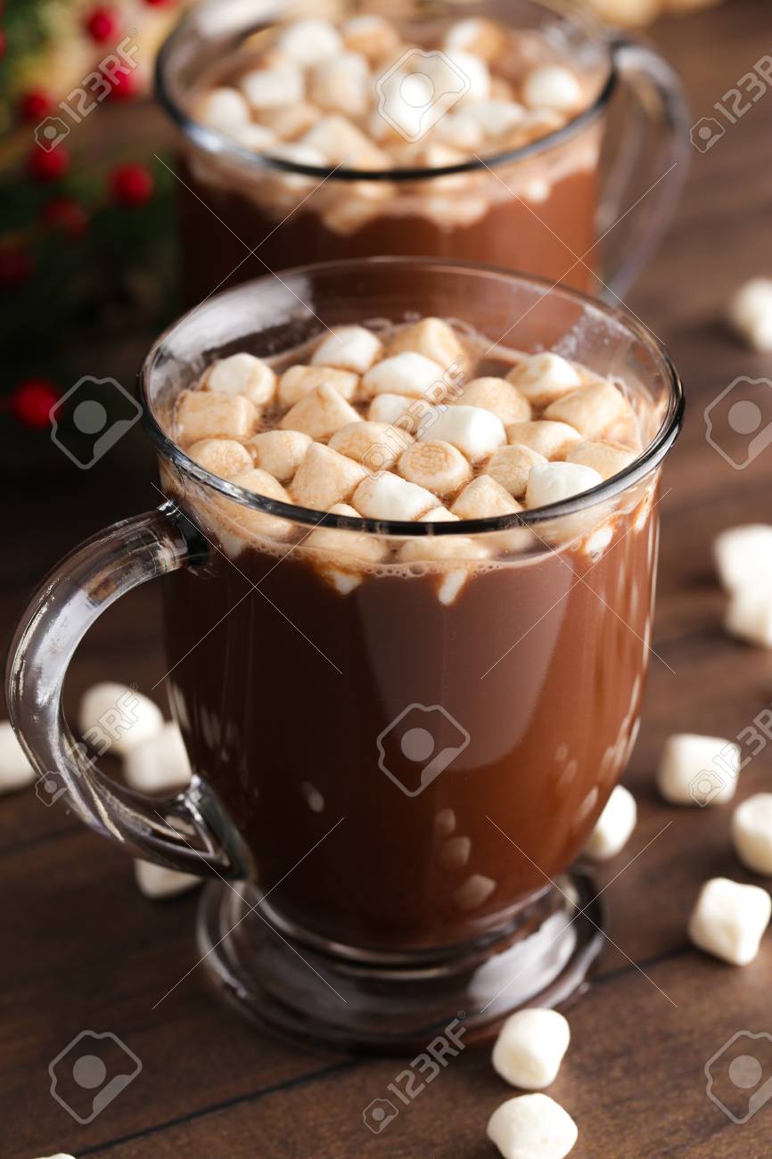 A Pair of Mugs Filled with Hot Chocolate and Marshmallows on a Wooden Table - 112030857 A Pair of Mugs Filled with Hot Chocolate and Marshmallows on a Wooden Table - 112030857