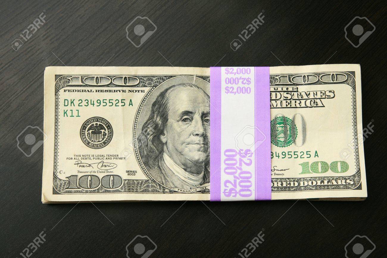 Two Thousand Dollars In 100 Bills On A Dark Wood Table Top Stock Photo Picture And Royalty Free Image Image