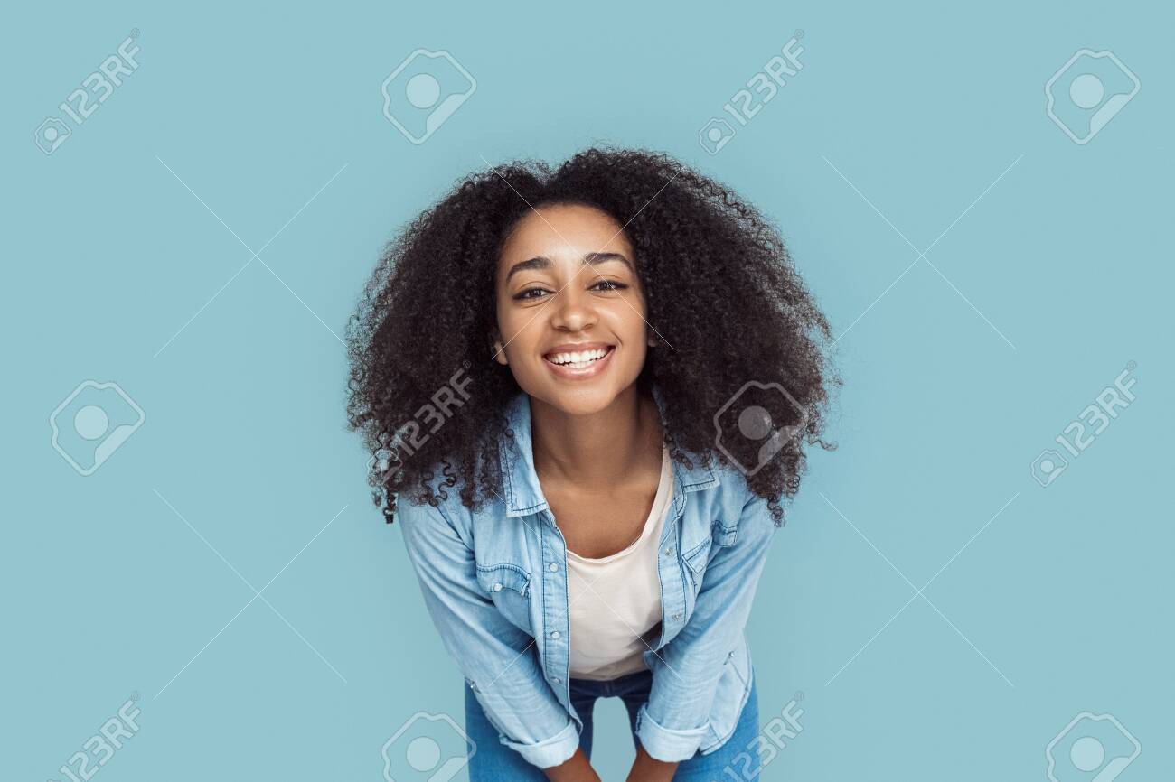 https://previews.123rf.com/images/pandorapictures/pandorapictures2002/pandorapictures200200268/140670064-freestyle-african-girl-standing-isolated-on-gray-leaning-forward-posing-to-camera-cheerful-close-up.jpg