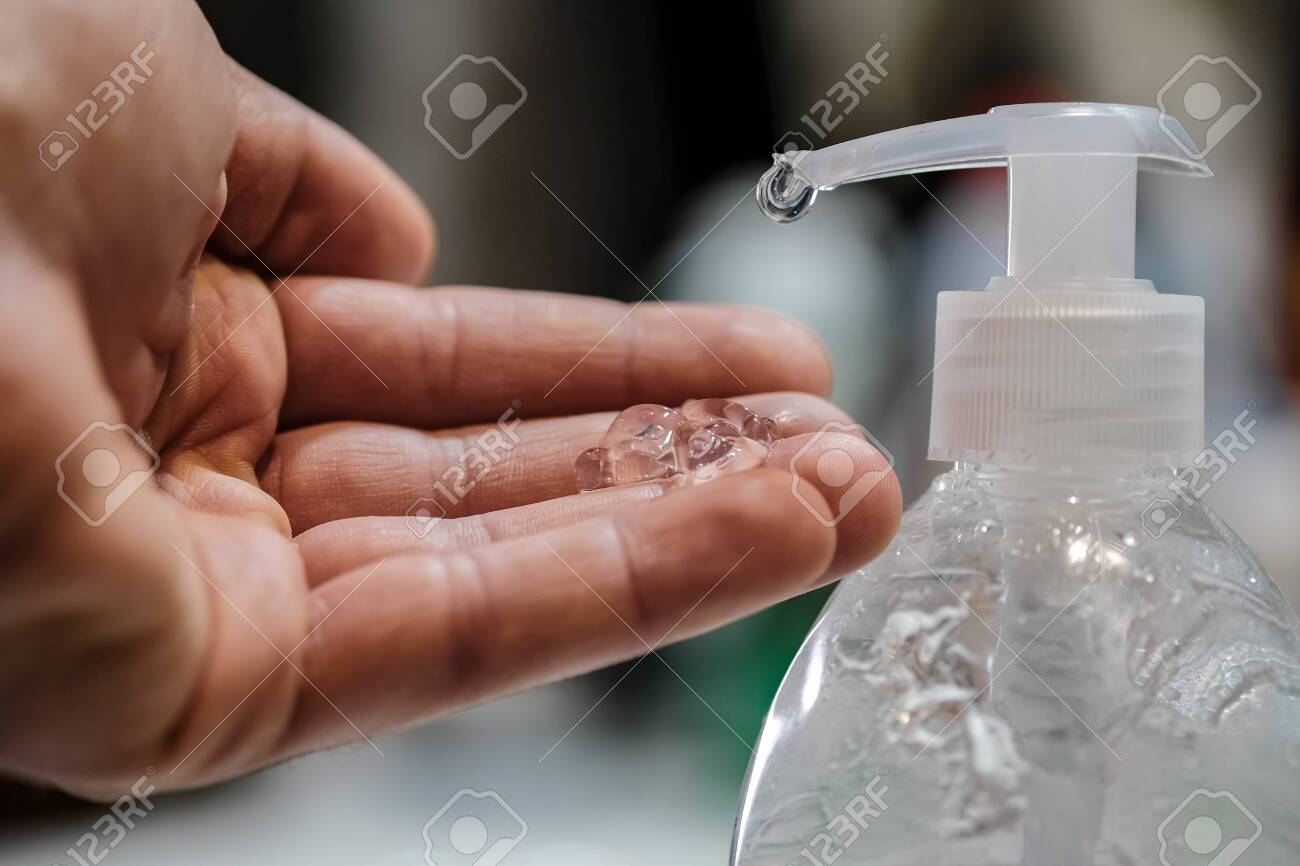 Man disinfecting with hand sanitizer dispenser,corona virus infection disease - 144511209 Man disinfecting with hand sanitizer dispenser,corona virus infection disease - 144511209