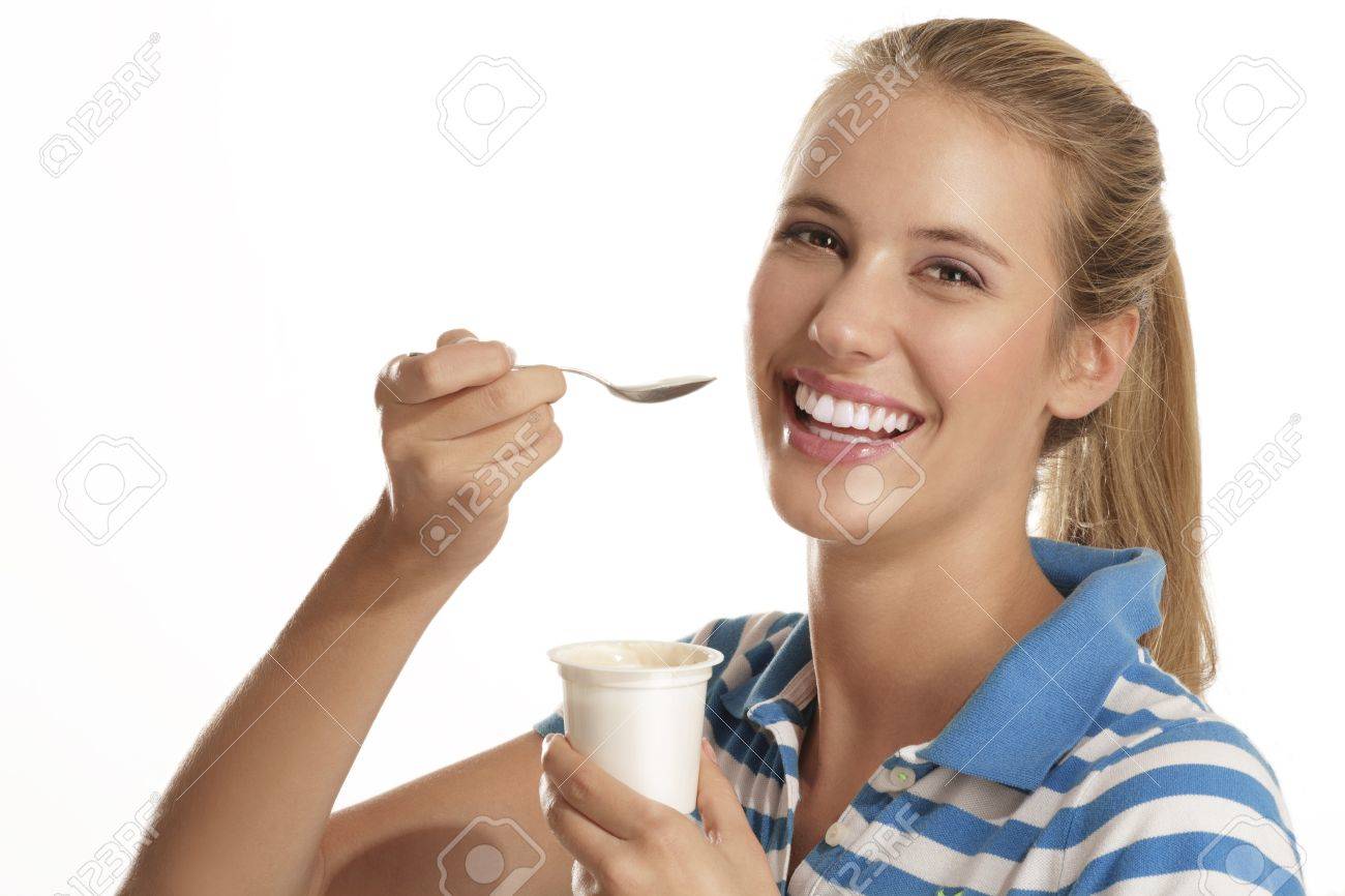 young woman eating yogurt on white background - 15937011 young woman eating yogurt on white background - 15937011