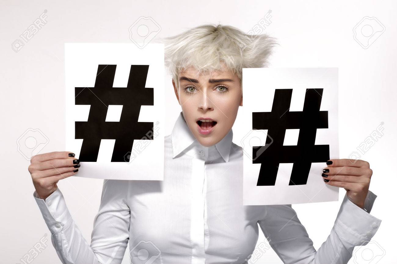 pretty blond model showing two hashtag sign on paper white background - 36360384 pretty blond model showing two hashtag sign on paper white background - 36360384