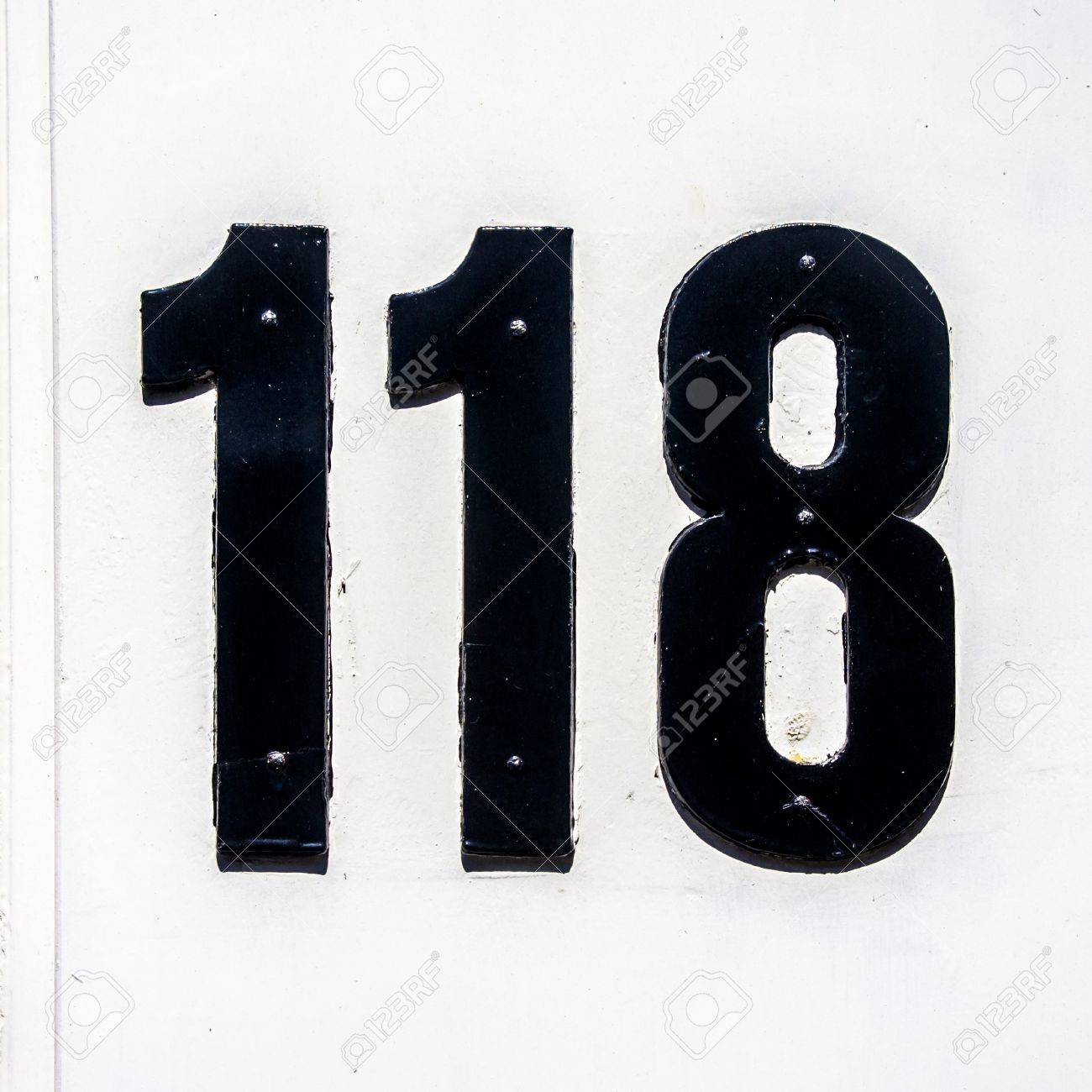 House Number One Hundred And Eight-teen Black Lettering On A White  Background Stock Photo, Picture and Royalty Free Image. Image 13836108.