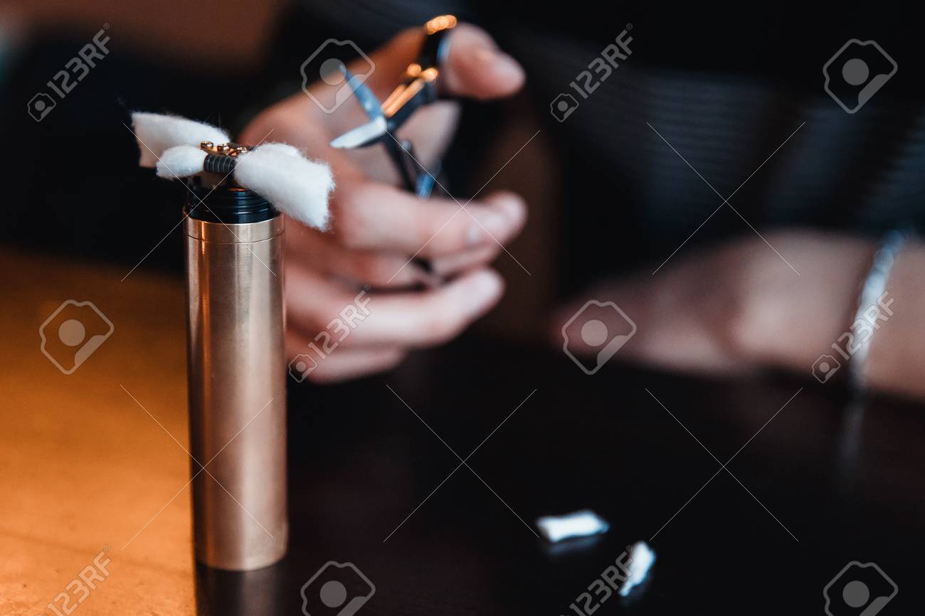 Vape Male Master Installed Cotton Wool To Refuel The Electronic Cigarette And Cut With Scissors Vaping Device Stock Photo Picture And Royalty Free Image Image 79856295