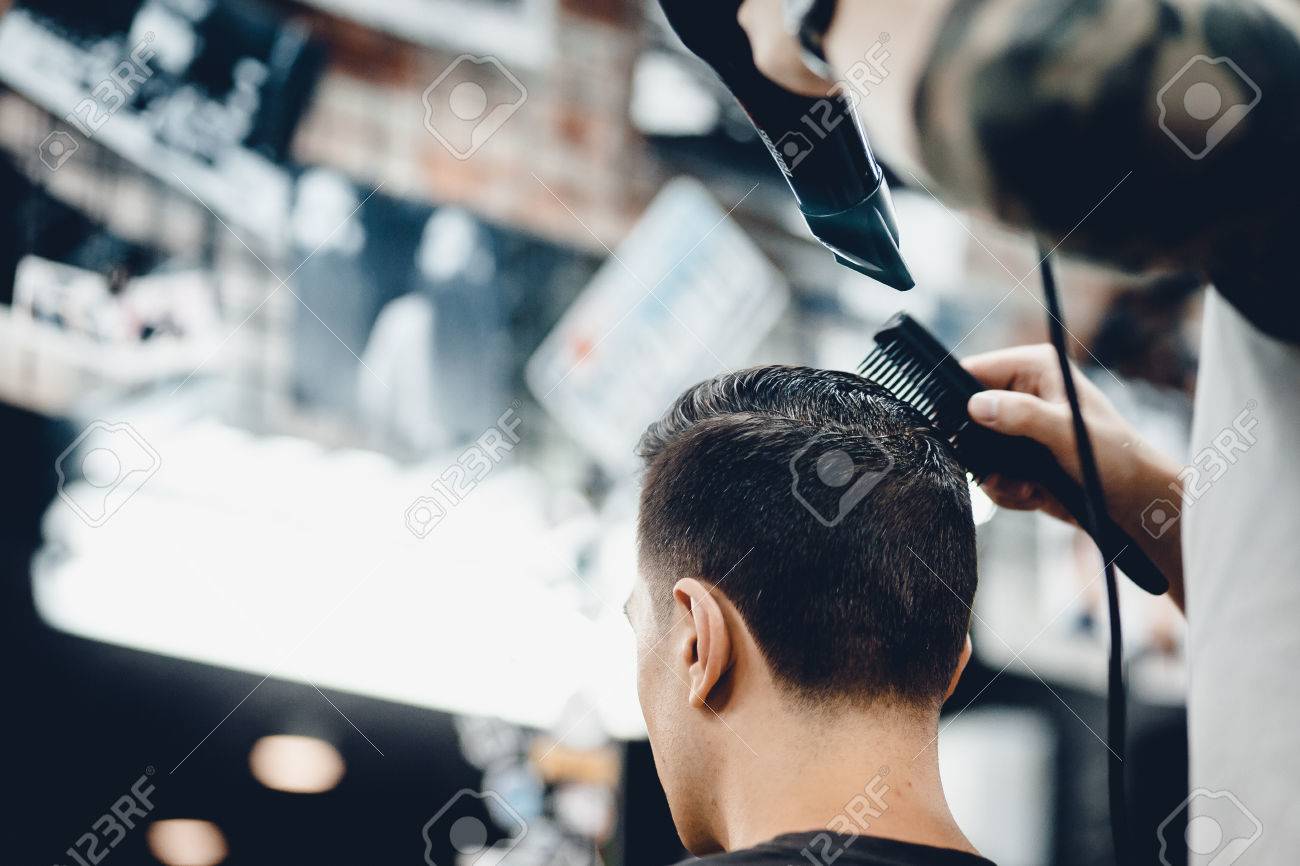 Male Hippy Customer In Barbershop Hairdresser On Fashionable