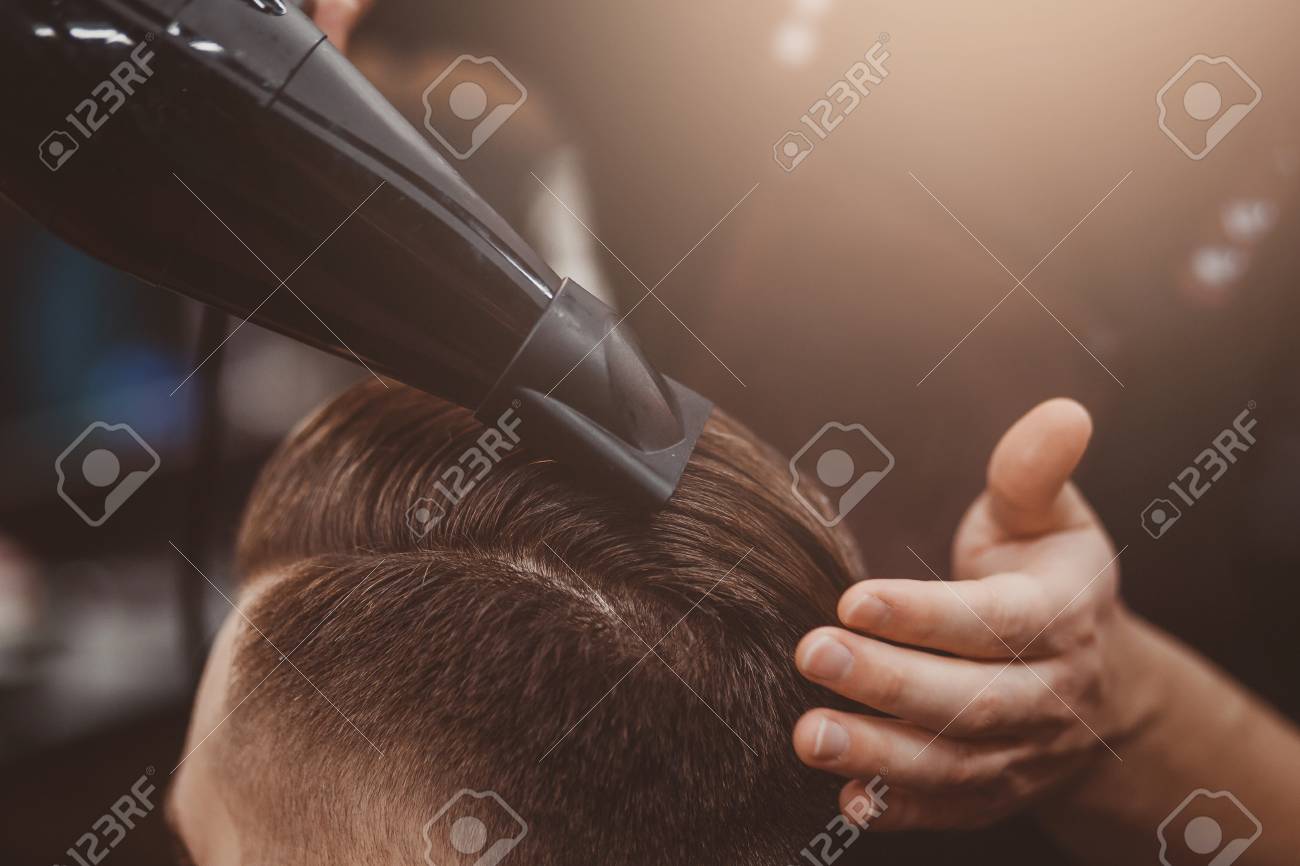 close up master barber does the hairstyle and styling with hair master barber