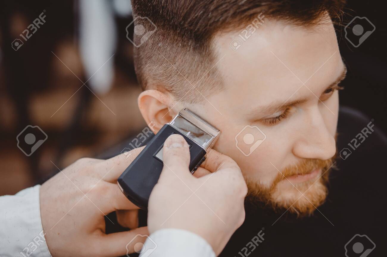 cutting hair with electric shaver