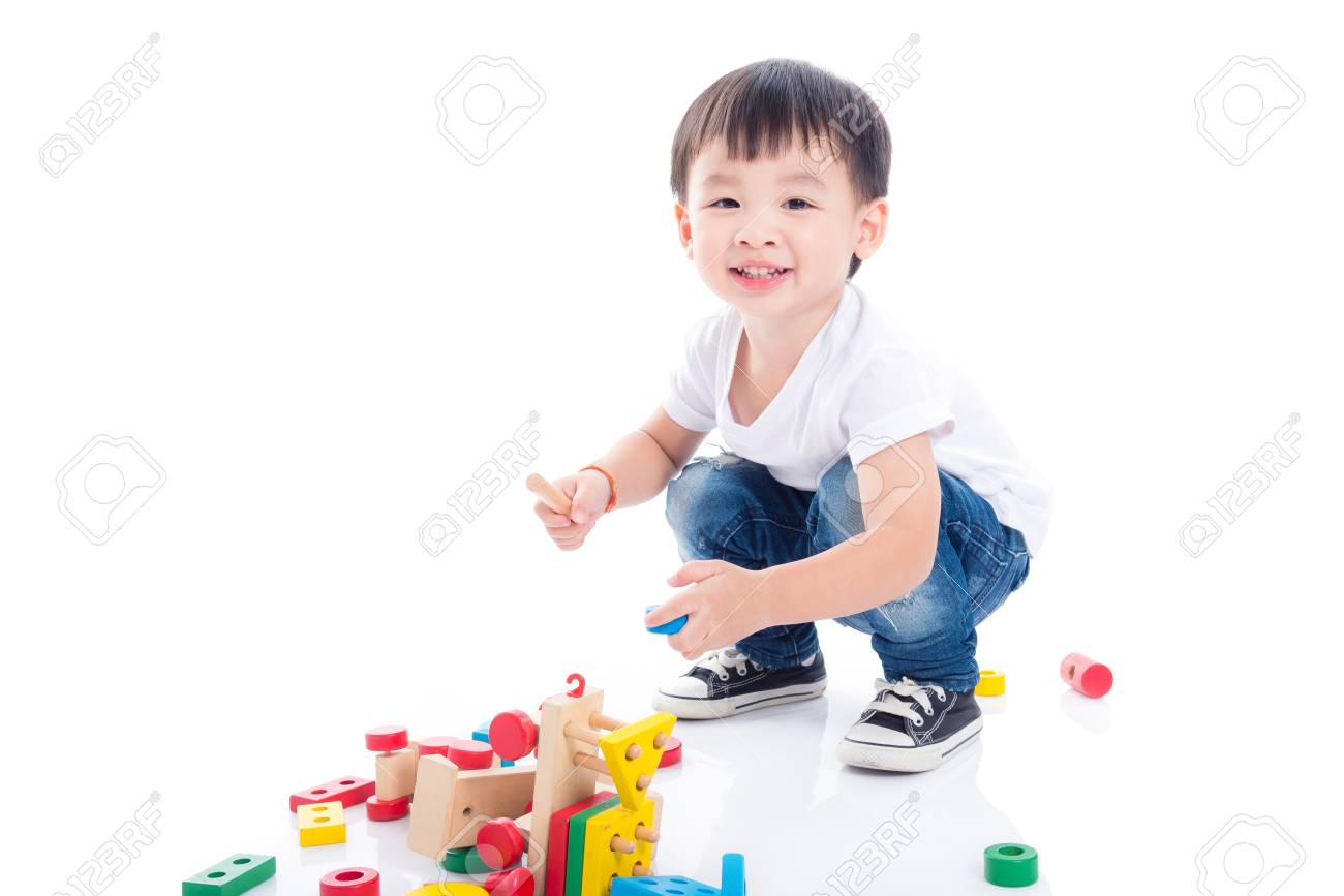 Little asian boy playing toy on the floor over white background - 105380311 Little asian boy playing toy on the floor over white background - 105380311