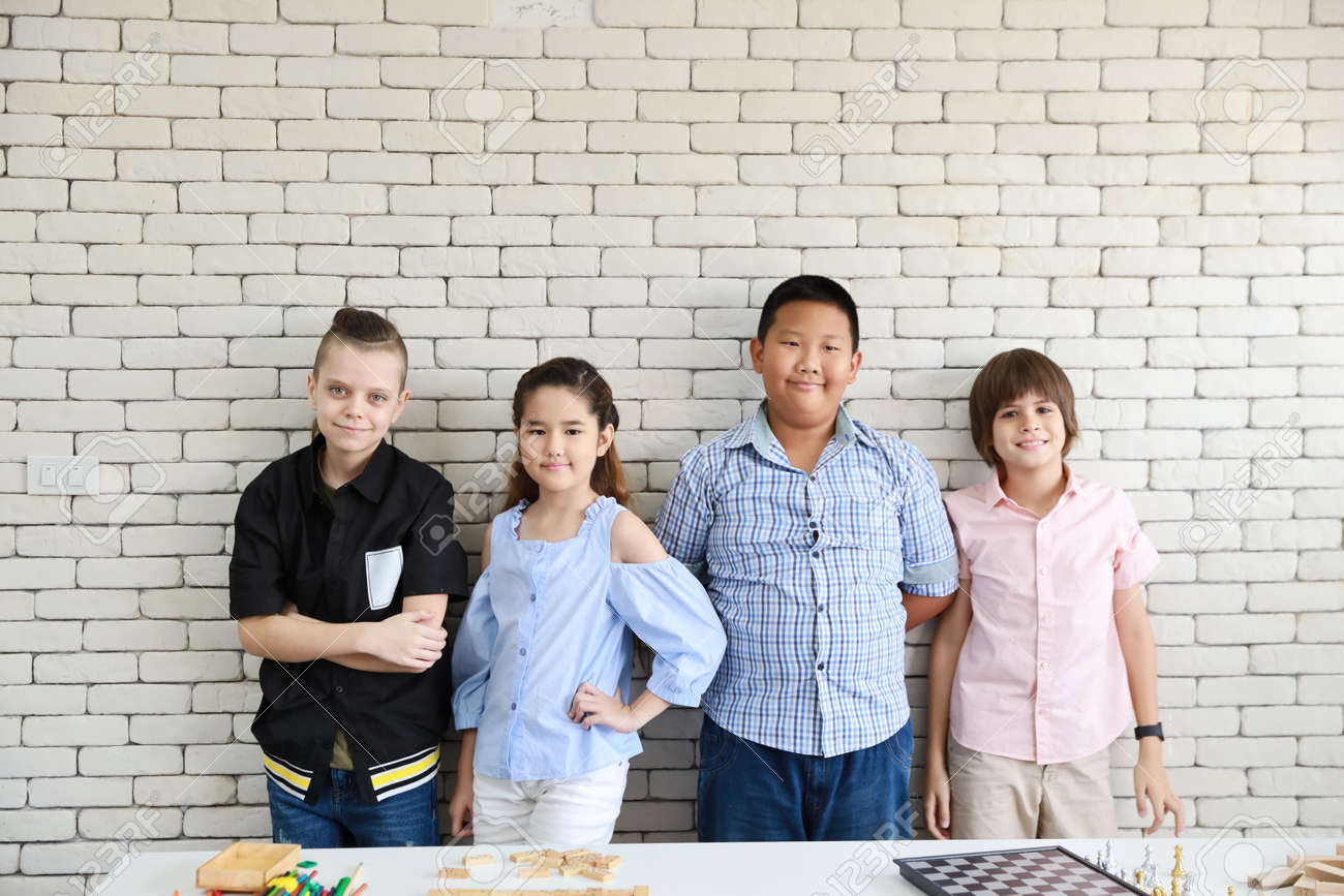 group of multiethnic international school kids standing and being confident in classroom with happy face with white wall (education concept) - 154507859 group of multiethnic international school kids standing and being confident in classroom with happy face with white wall (education concept) - 154507859