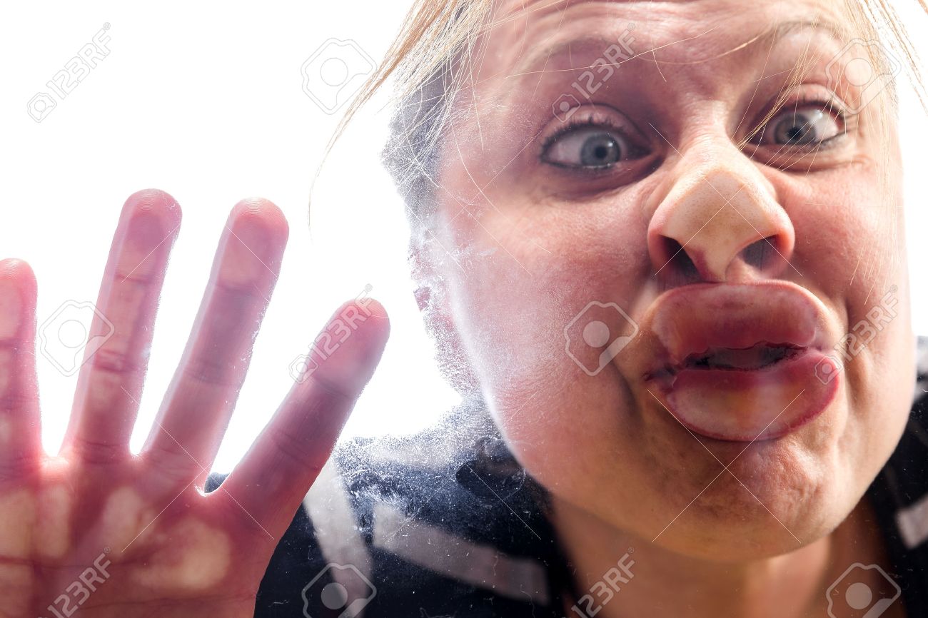 woman with fish mouth at the window makes a funny grimace - 54306363 woman with fish mouth at the window makes a funny grimace - 54306363