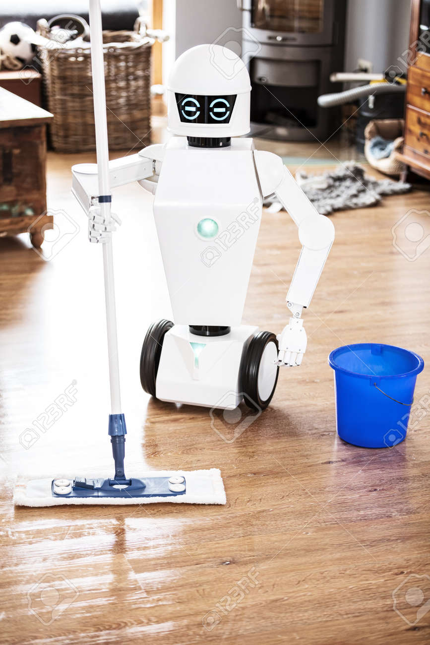 automatic robot floor scrubber is doing his work in an living room, vertical shot with copyspace - 168974764 automatic robot floor scrubber is doing his work in an living room, vertical shot with copyspace - 168974764