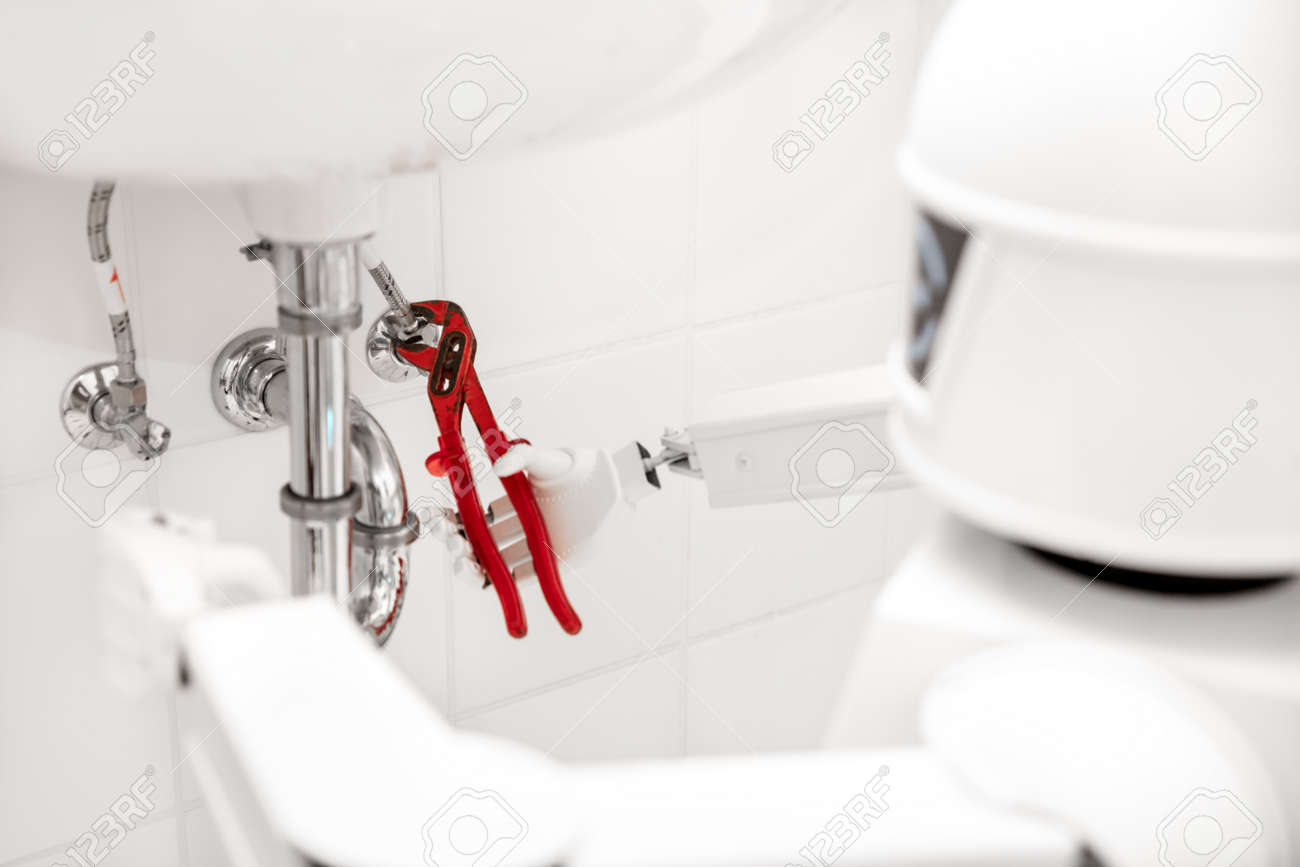 Autonomous service robot is fixing something in the bathroom, with an pipe wrench under the sink - 168974776 Autonomous service robot is fixing something in the bathroom, with an pipe wrench under the sink - 168974776