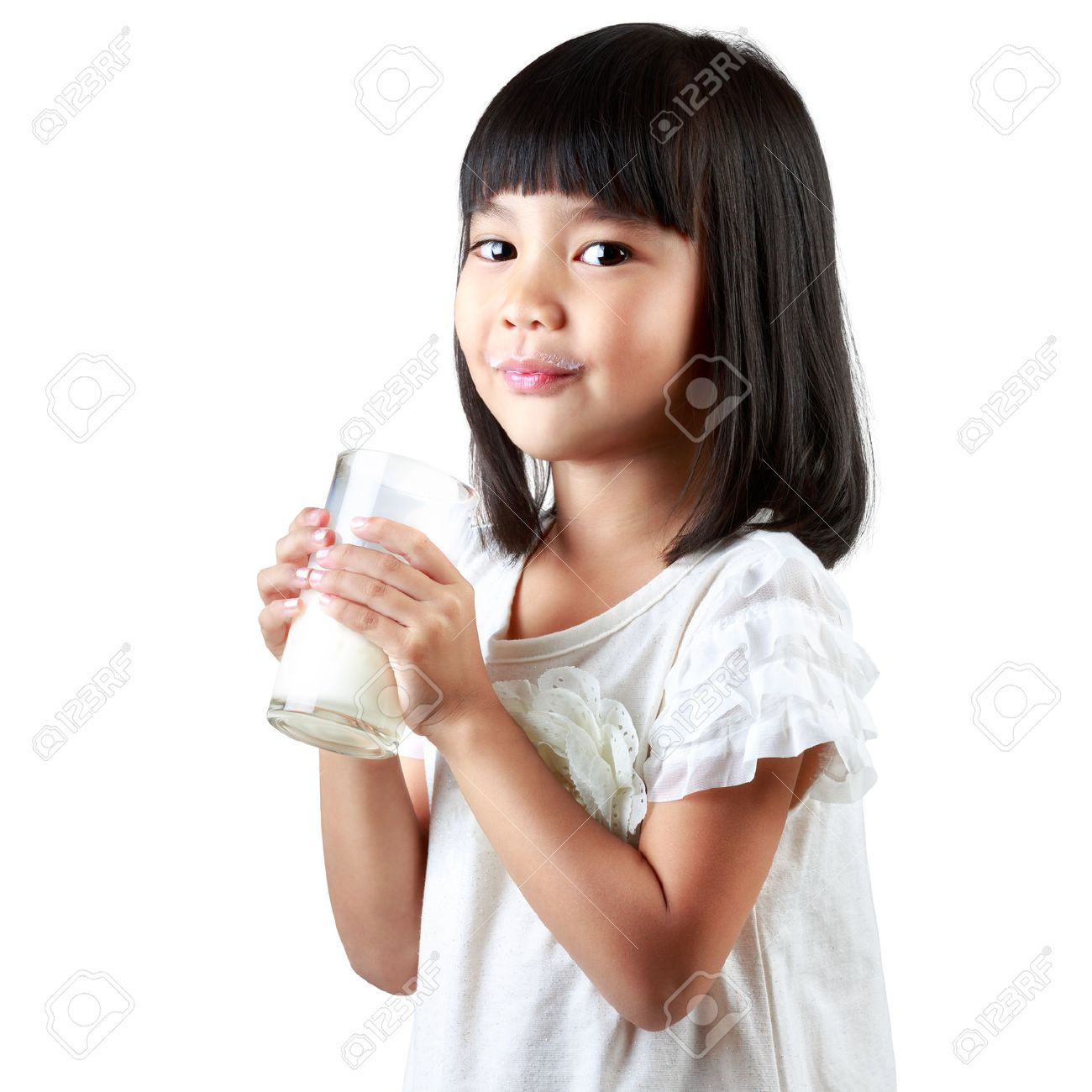 Happy Little Asian Girl Holding A Cup Of Milk Isolated Over White Stock Photo Happy Little Asian Girl Holding A Cup Of Milk Isolated Over White Stock Photo