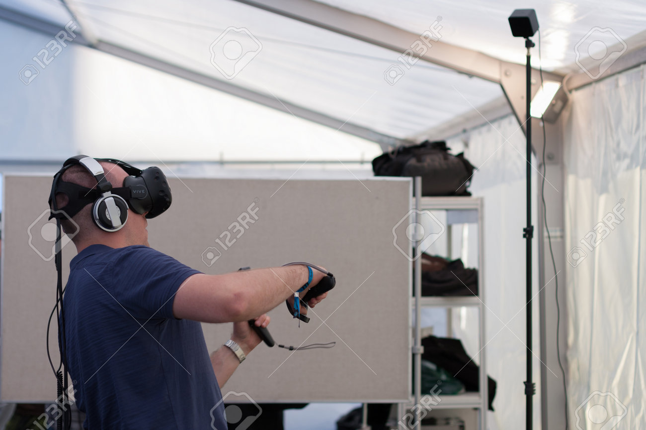 BRNO, CZECH REPUBLIC - APRIL 30, 2016: Young man with VR - glasses and controllers plays game at Animefest, anime convention on April 30, 2016 Brno, Czech Republic - 58008622 BRNO, CZECH REPUBLIC - APRIL 30, 2016: Young man with VR - glasses and controllers plays game at Animefest, anime convention on April 30, 2016 Brno, Czech Republic - 58008622