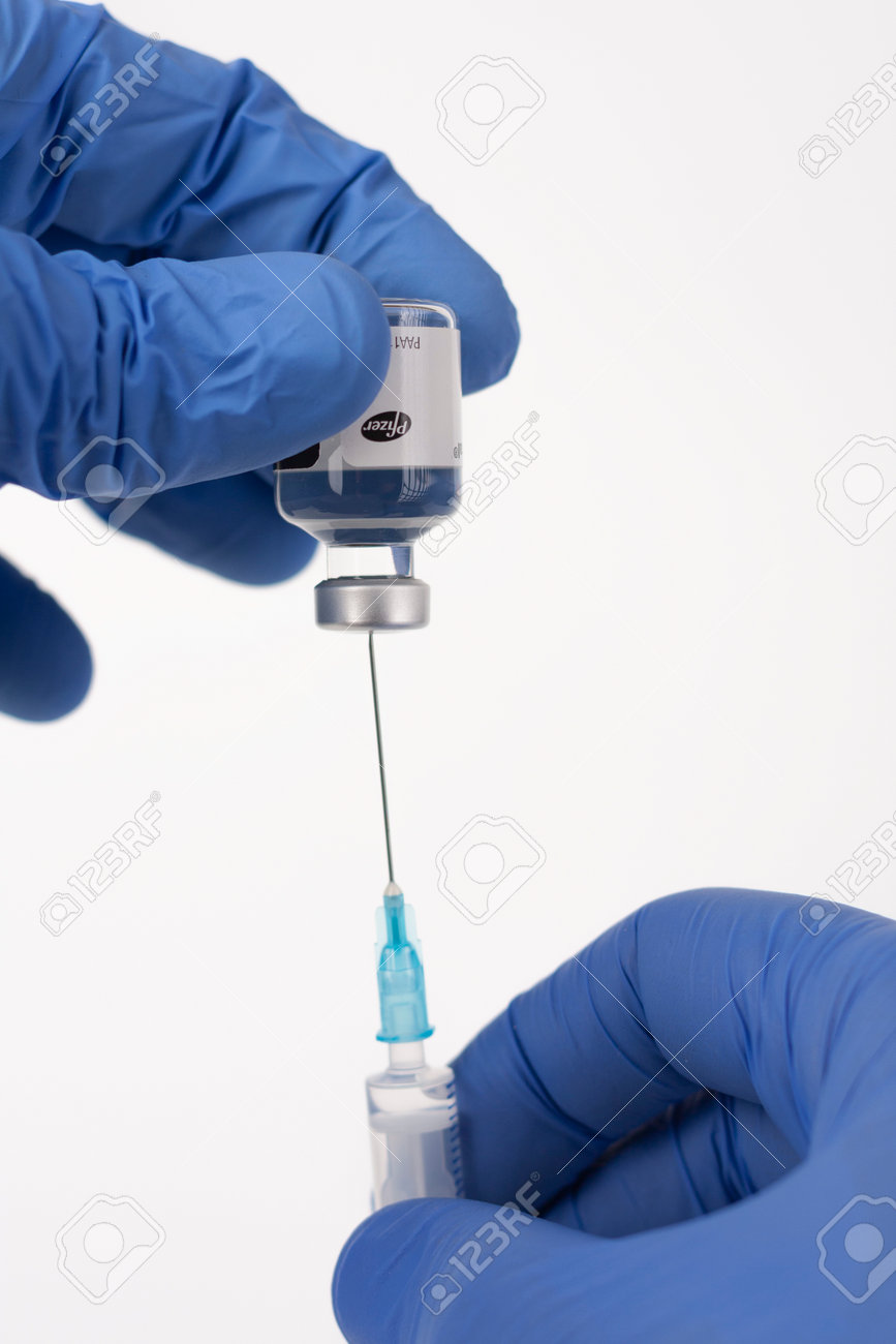 Brnenec, Czech Republic - December 12, 2020: Fingers in gloves, syringe and vial of Epanutin. Epanutin is produced by Pfizer. Pharmaceutical corporation Pfizer also developed a vaccine on Covid-19. - 161915003 Brnenec, Czech Republic - December 12, 2020: Fingers in gloves, syringe and vial of Epanutin. Epanutin is produced by Pfizer. Pharmaceutical corporation Pfizer also developed a vaccine on Covid-19. - 161915003