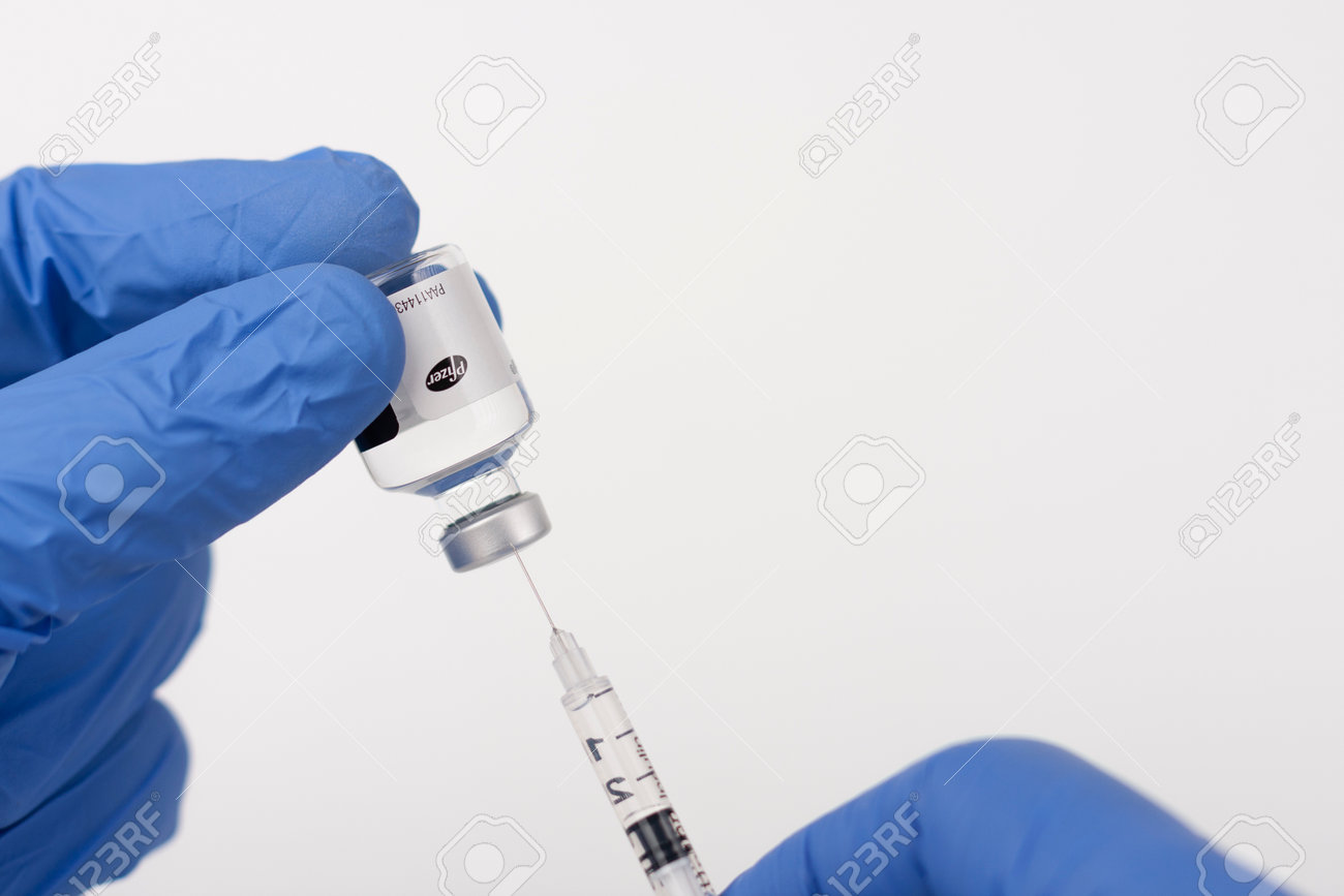 Brnenec, Czech Republic - December 12, 2020: Fingers in gloves, syringe and vial of Epanutin. Epanutin is produced by Pfizer. Pharmaceutical corporation Pfizer also developed a vaccine on Covid-19. - 161915006 Brnenec, Czech Republic - December 12, 2020: Fingers in gloves, syringe and vial of Epanutin. Epanutin is produced by Pfizer. Pharmaceutical corporation Pfizer also developed a vaccine on Covid-19. - 161915006