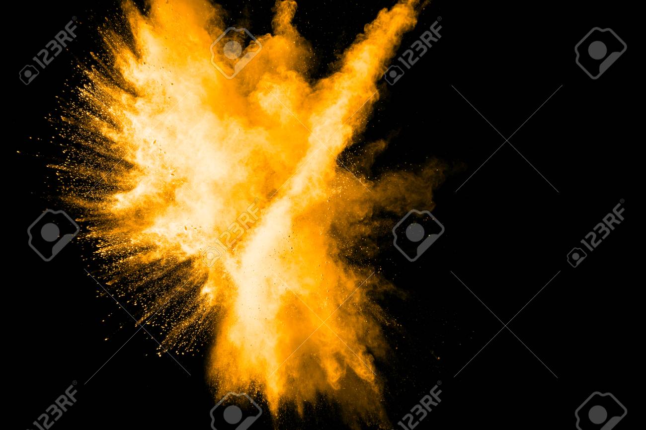 yellow color powder explosion cloud isolated on black background