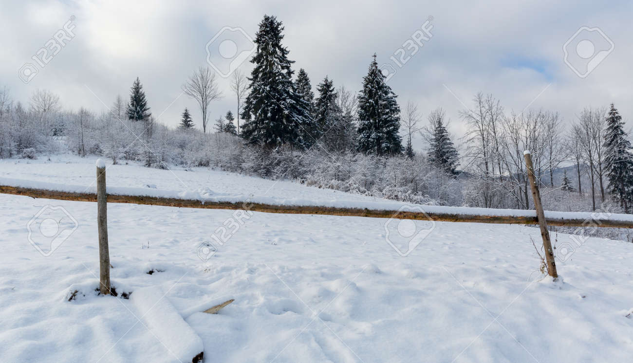 Landscape with wooden fence on winter meadow in mountains - 165451750 Landscape with wooden fence on winter meadow in mountains - 165451750