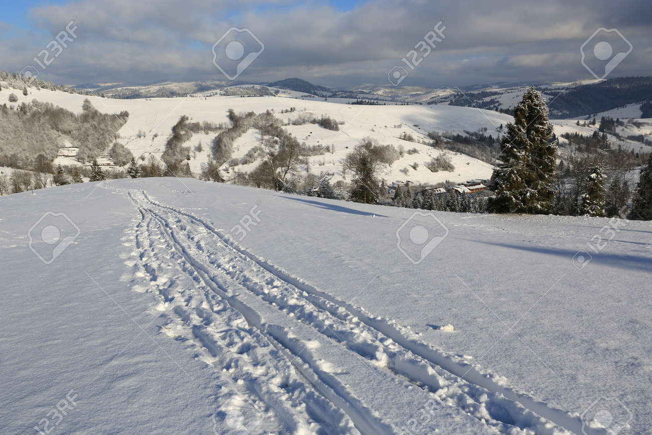 Scene with trail on winter mountain slope, Carpathians in Ukraine - 165452357 Scene with trail on winter mountain slope, Carpathians in Ukraine - 165452357
