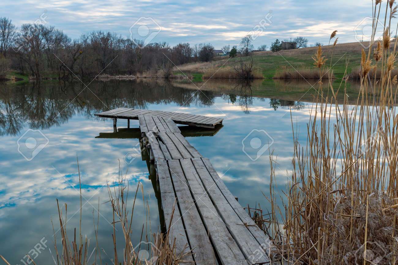 wooden firshing bridge on rural lake at evening time - 168208872 wooden firshing bridge on rural lake at evening time - 168208872